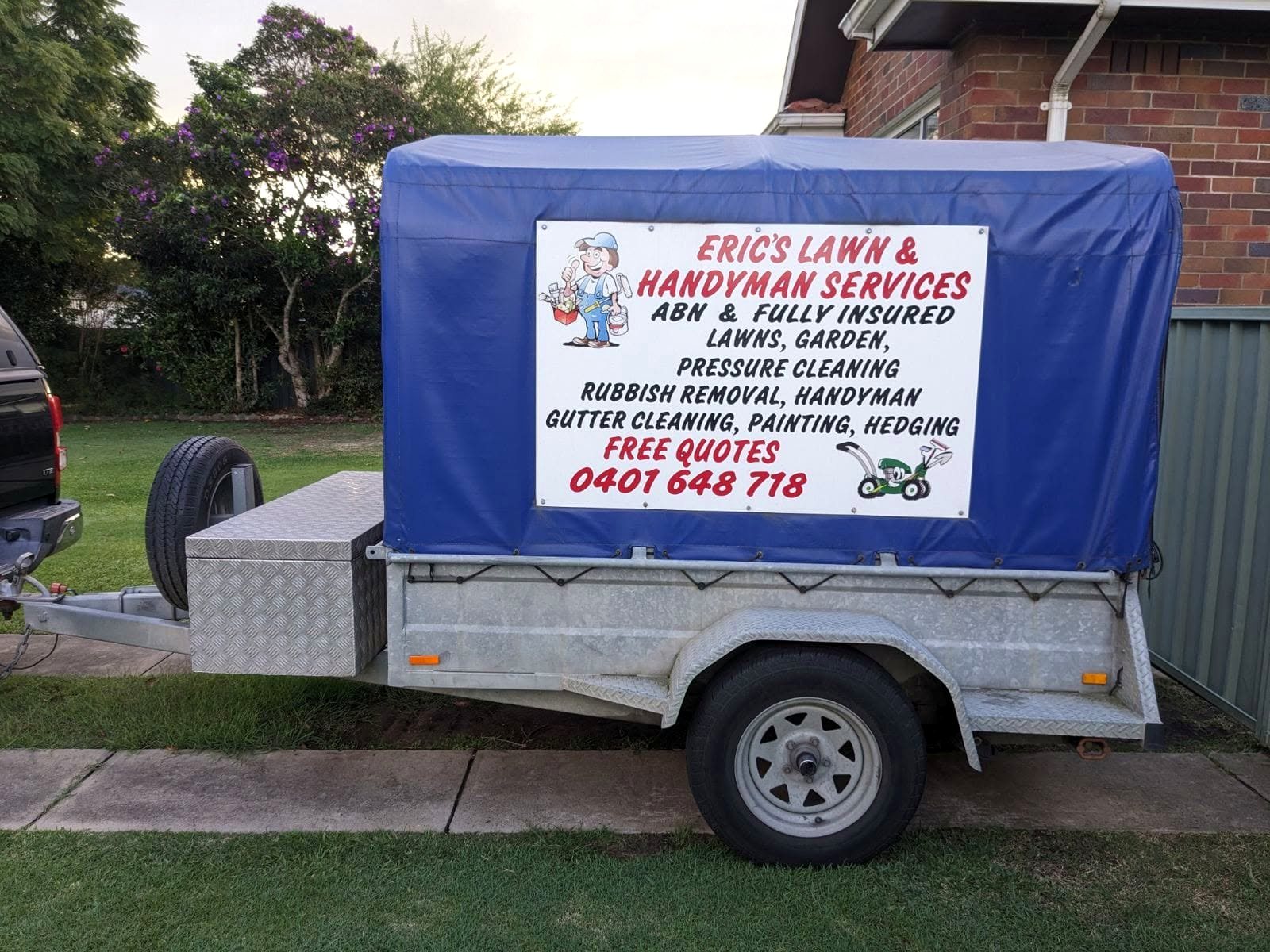 Trailer with Eric's Lawn and Handyman Services sign